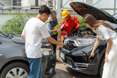 Bir adam ve bir kadın arabanın kazasındaki çizikleri gösterirken bir araba sigortacısı ve bir sihirbaz da arabanın diğer tarafındaki sigorta poliçesini inceliyor.