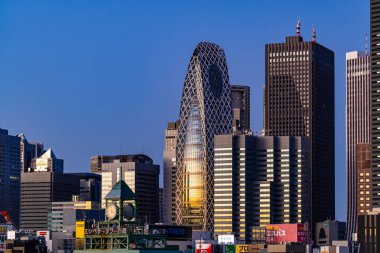 Tokyo, Japan - 15 December 2024 - View of the Mode Hal Iko Building during early morning sunrise against clear blue sky clipart