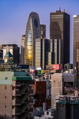 Tokyo, Japan - 15 December 2024 - View of the Mode Hal Iko Building during early morning sunrise against clear blue sky clipart