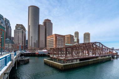 Boston, MA, ABD - 12 Şubat 2025 - Boston şehri ve gökdelenleri güzel bir kış öğleden sonra Seaport bulvarı köprüsünden görüldü