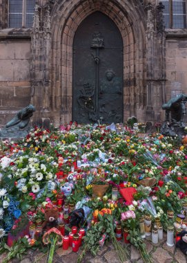 Magdeburg saldırısının kurbanlarına başsağlığı, çiçekler ve oyuncaklar. Terörist saldırısından sonra. Dikey fotoğraf