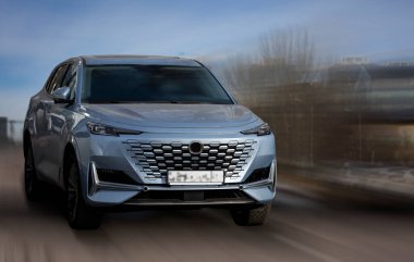 Acura blue car on a motion blurred background.