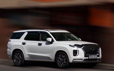 Hyundai beyaz arabası arka planda bulanık.