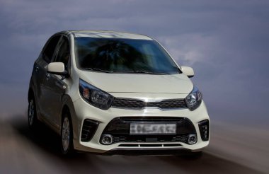 Hareket bulanık arkaplanda Kia beyaz araba.