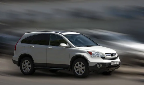 stock image Honda white car on a motion blurred background.