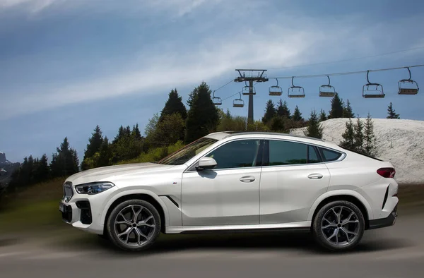 stock image BMW white car on a motion blurred background.