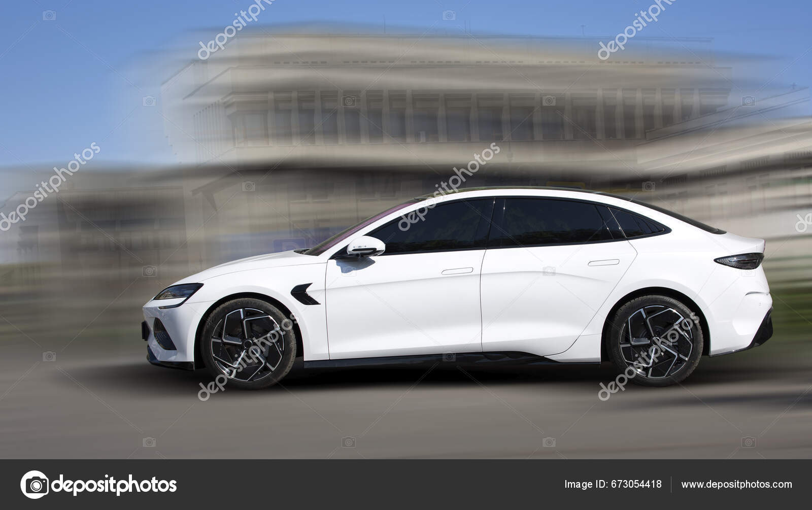 Build your dreams white electric car motion blurred background stock