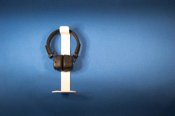 Kulaklıklar mavi arkaplana karşı, onlar için beyaz ekleme tutucular