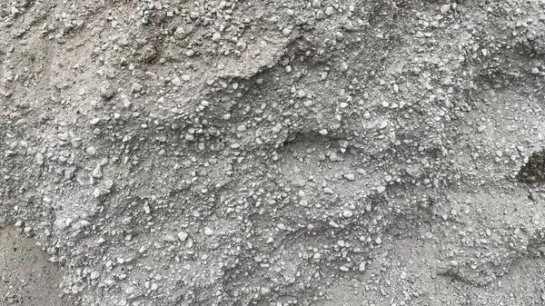 stock image Texture of building bulk material spilling out in a large pile on the street