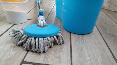 Vacuum cleaner and mop with bucket on the floor clipart