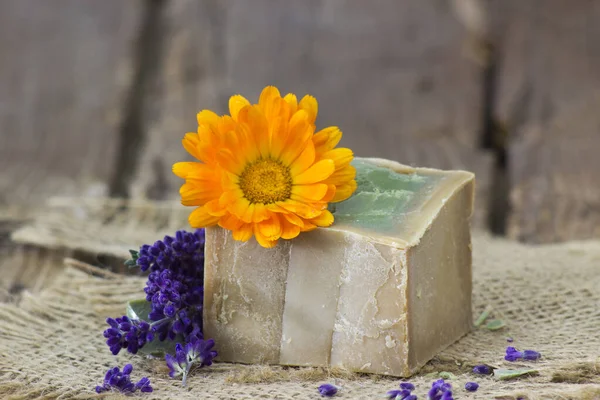 stock image Natural handmade soap with calendula and lavender on old rustic background