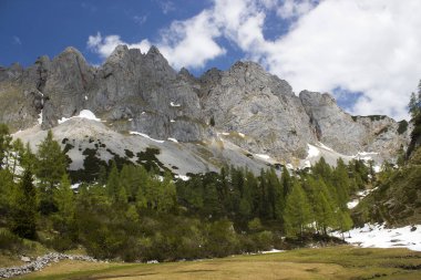 Panorama of massive Alpine mountains. Landscape in the Austrian Alps of the Dachstein region (Styria in Austria) clipart