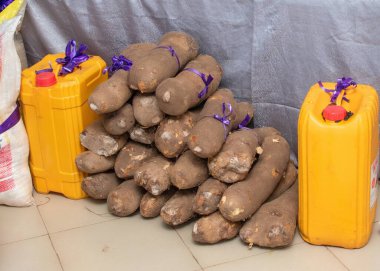 Yams neatly piled up, arranged and decorated along with other food items as part of traditional wedding list of bride price in a Nigeria