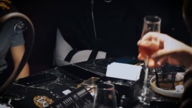 Clinking glasses of champagne. Toast celebrating christmas. Dark background. A lot of hands. A group of friends