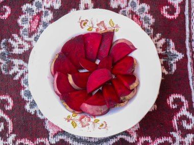 Fresh Organic Beetroot Slices served in a bowl on a wooden background. This fruit is usually made into juice or salad