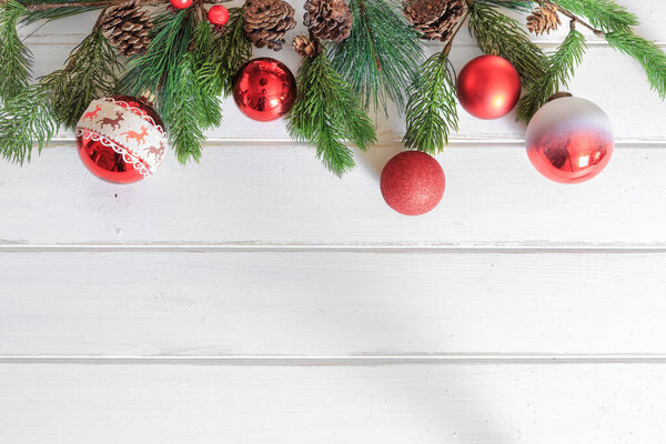 Christmas background with decorations on white wooden board. View with copy space