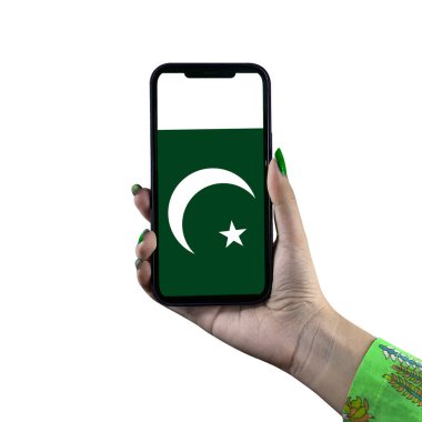 Pakistan Flag display in smartphone hold by young Asian female or woman hand. Patriotism with modern cellphone technology display. Isolated on white background. clipart