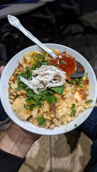 Bubur ayam is one of the names of typical Indonesian food with complete portions accompanied by shredded chicken, peanuts and crackers as a complement