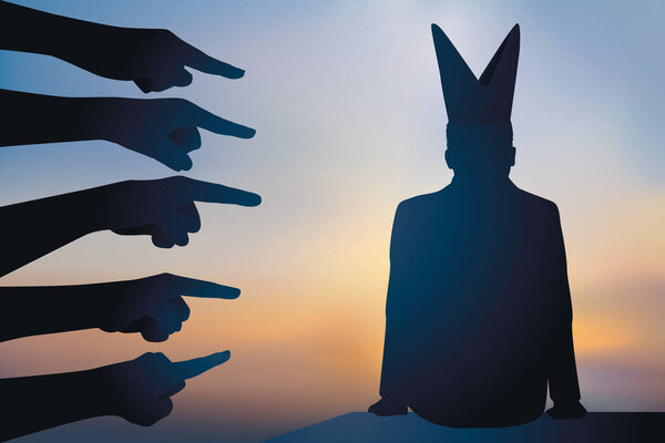 Concept of discrimination and moral harassment with a man being pointed out because he wears a dunce cap.