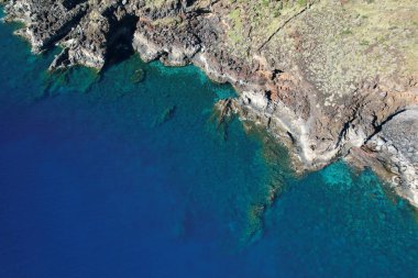 Beautiful clear ocean at the volcanic coast of El Hierro, Canary Islands. Aerial top view. Relaxing natural background.