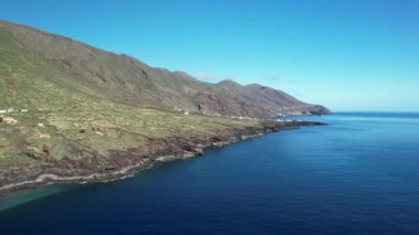 Volcanic island El Hierro surrounded by blue ocean. Drone shot of natural landscape and coastline. Traveling on the Canary Islands, Spain.