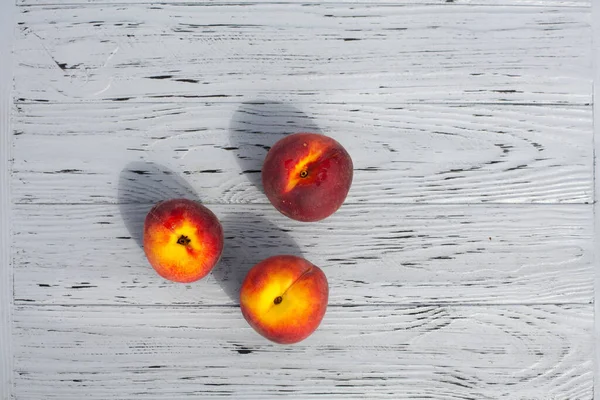 Still Life Three Ripe Appetizing Peaches Light Wooden Textured Table — Stockfoto