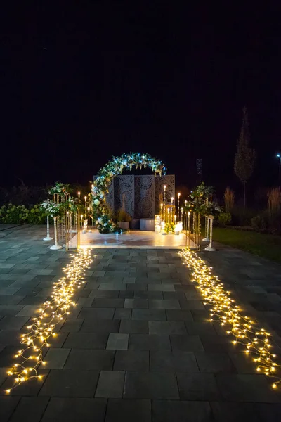Stilvoller Hochzeitsbogen Aus Kerzen Laternen Und Frischen Blumen Nachts Beleuchtet — Stockfoto