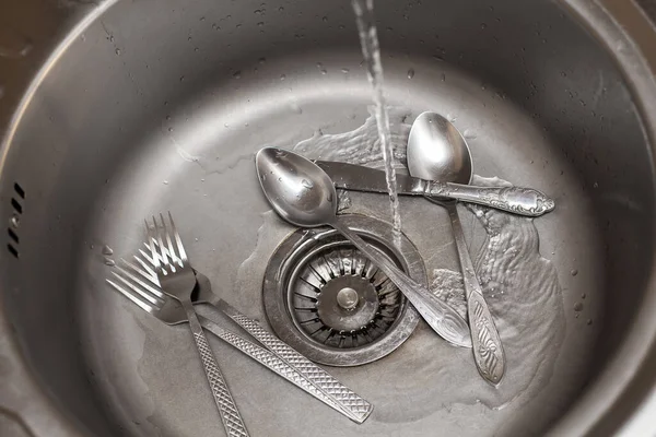 食器洗いの構成 水道水のジェットがフォークやスプーンで洗面台に注ぐ キッチンケア 清潔感に関するイメージ — ストック写真