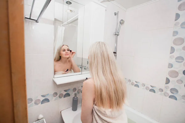 Beyaz Havlulu Sarışın Bir Kadın Kirpiklerini Rimelle Boyuyor Banyoda Dikiliyor — Stok fotoğraf