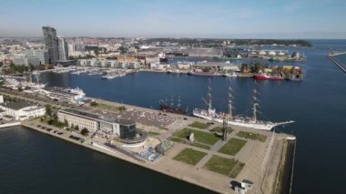 Güneşli bir yaz gününde Gdynia Limanı 'nın hava manzarası, dalgakıran ve rıhtımdaki yelkenli gemi..