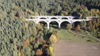 Stanczyki 'deki eski köprünün havadan görünüşü güneşli bir sonbahar gününde Suwalki bölgesinin ormanları ve tarlaları arasında..