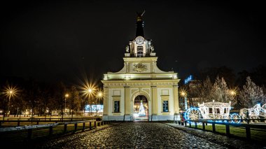 The gate in the Branicki Palace and the luminous carriage in night lighting in bialystok.
