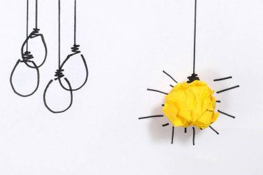 Yaratıcı düşünceler ve yenilik kavramı. Ampul sembollü kağıt küre sarı renk.