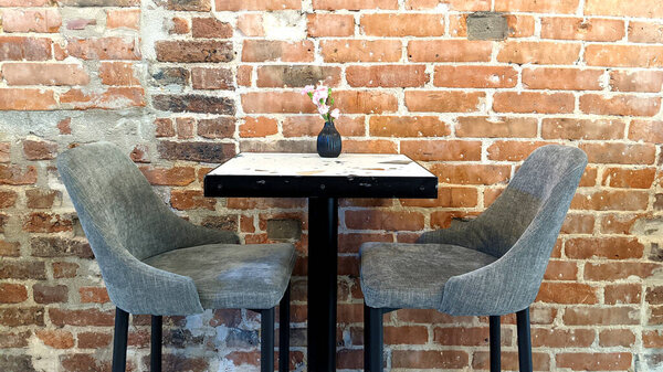 table and chairs on the background of a brick wall