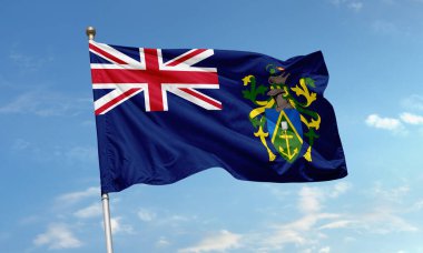 İngiliz Birliği bayraklı Tristan da Cunha bayrağı ve mavi gökyüzüne karşı rüzgarda savrulan ada arması.