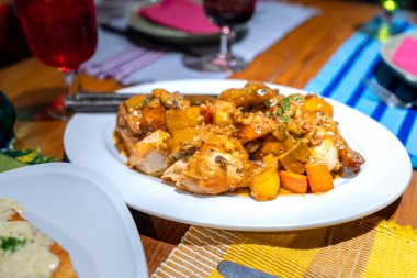 Baked chicken with mushroom sauce, minced potato and carrots.