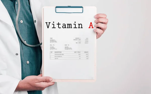 Doctor holding Paper Pad with Text Vitamin A
