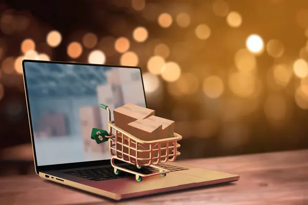 Online shopping and delivery service concept.Brown paper boxs in a shopping cart with laptop keyboard on wood table on the public park background.Easy shopping with finger tips for consumers.