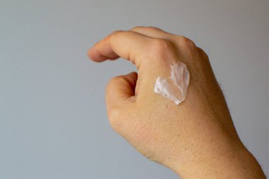 Cream on a female female hand in the shape of a heart