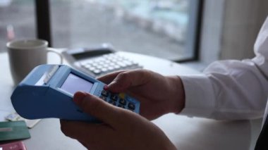 Businessman swiping card for overdraft consumption with POS machine