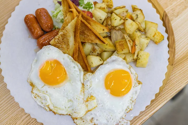 Kahvaltı için patates, salata ve ekmek tabağında kızarmış yumurta..