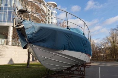 Preparing boats for winter. Storage of boats and yachts. Boat cover. clipart