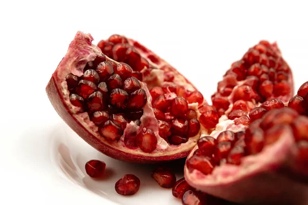 stock image Opened juicy pomegranate fruit isolated on white background. Red pomegranate, healthy food.