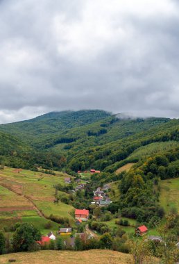 Vertical panoramic landscape mountain village.Dramatic panoramic landscape view of the mountains and cloudy sky. High quality photo