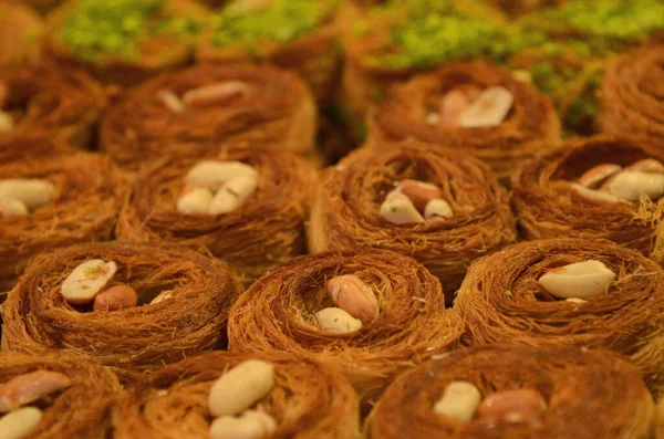 stock image Turkish baklava. Eastern market, counter. Arabic dessert made from honey and syrup. Oriental sweets with peanuts, almonds and pistachio nuts