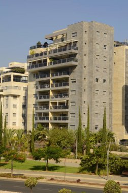 Güzel bir ev. Modern konut. İsrail - yüksek binalar, çiçekler ve palmiye ağaçları. Konsept: yaşamak için güzel bir yer, emlak satın almak için İsrail Rishon Le Zion Ekim 2022