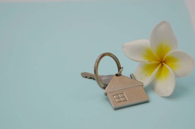 Dairenin anahtarları, ev. Sahilde mülk satın almak, deniz kenarında ev kiralamak. Plumeria çiçeği - tropikal yönün bir sembolü