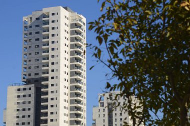Beautiful white residential buildings. Modern area, new buildings. Real estate in Israel. Tenement house Tall new residential buildings against the sky, space for text
