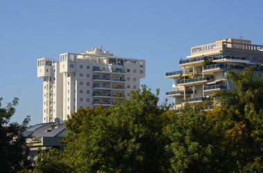 Beautiful white residential buildings. Modern area, new buildings. Real estate in Israel. Tenement house Tall new residential buildings against the sky, space for text