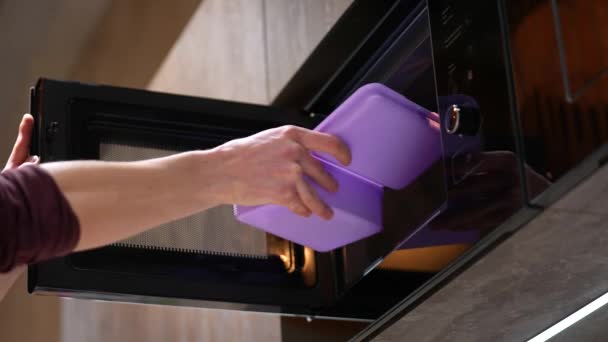 Man Hand Puts Plastic Container Food Microwave Slow Motion Concept — Αρχείο Βίντεο